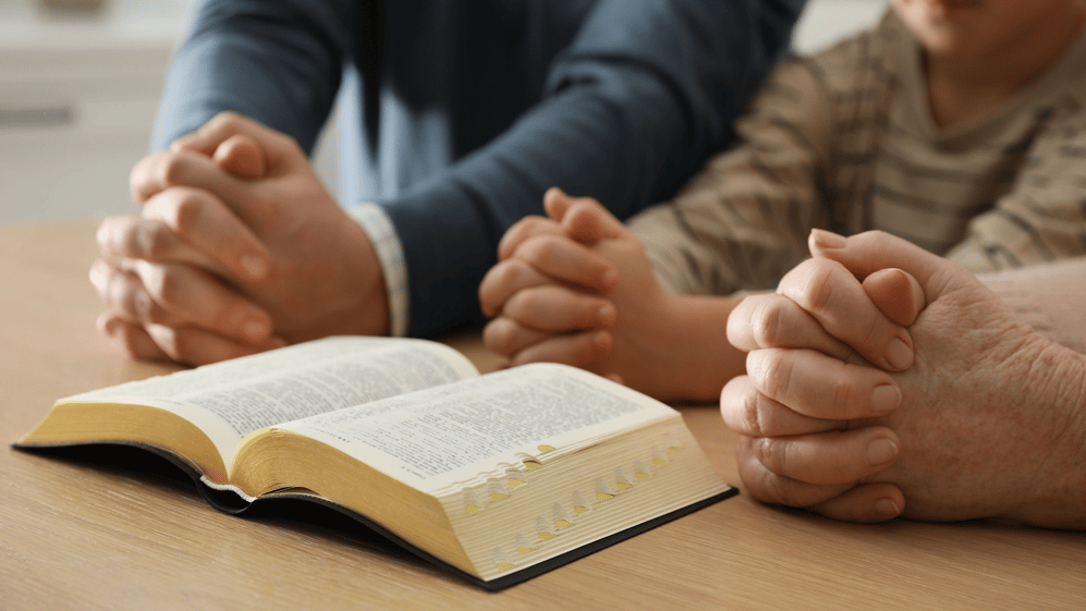Adults setting example in Bible study for youth