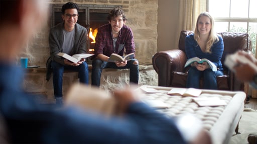 Group of young adults sit together at a Bible study