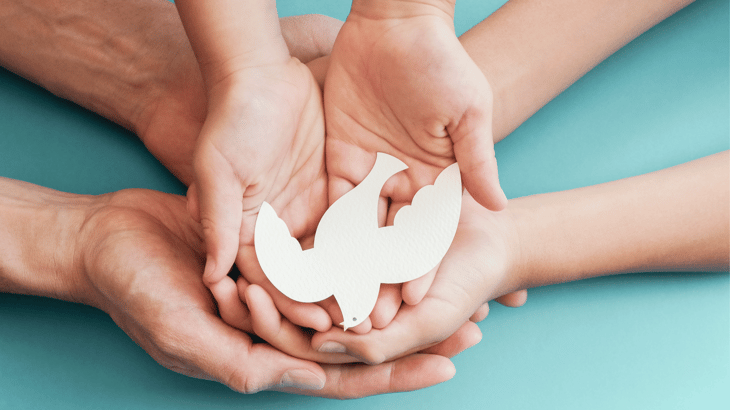 Family Hands Holding Dove of Peace