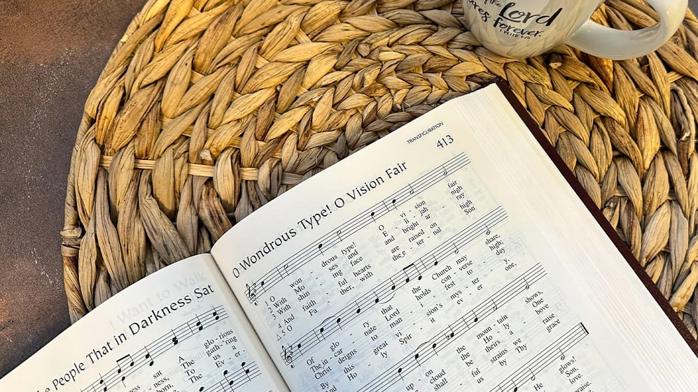Lutheran Service Book next to a cup of coffee