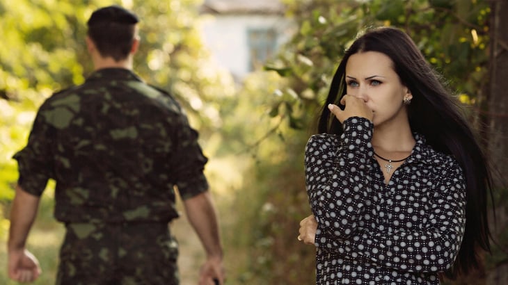Woman looking lonely and afraid as spouse heads out on military deployment