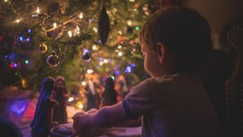 Little boy playing with nativity set