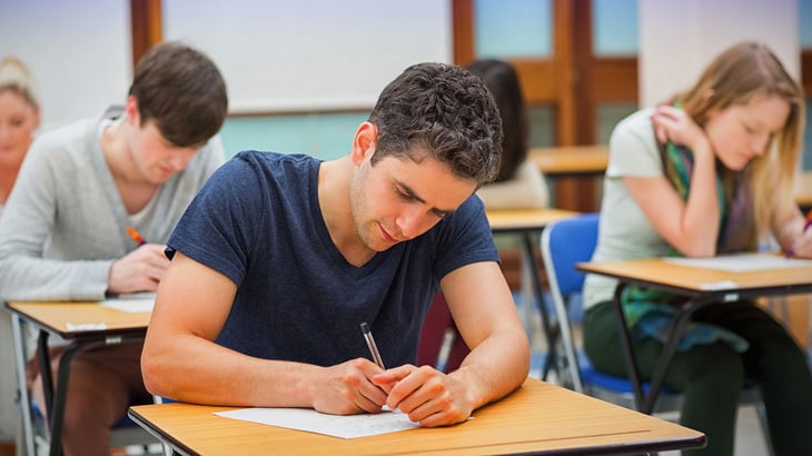 Student doing an exam in classroom