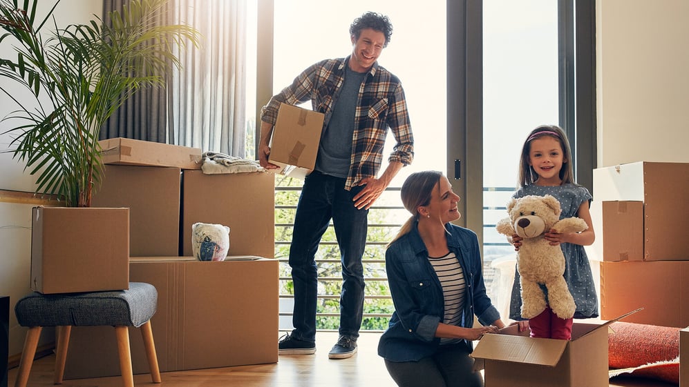 Family unpacks moving boxes in new home