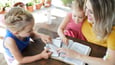 Mother reading Scripture with her young children