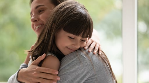 Woman hugging her daughter 