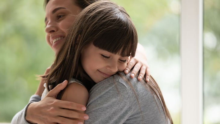 Woman hugging her daughter 