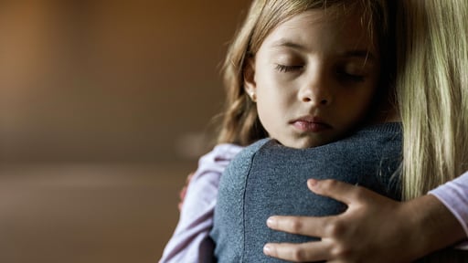Mother comforts young daughter