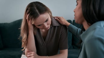 Woman comforting stressed friend 