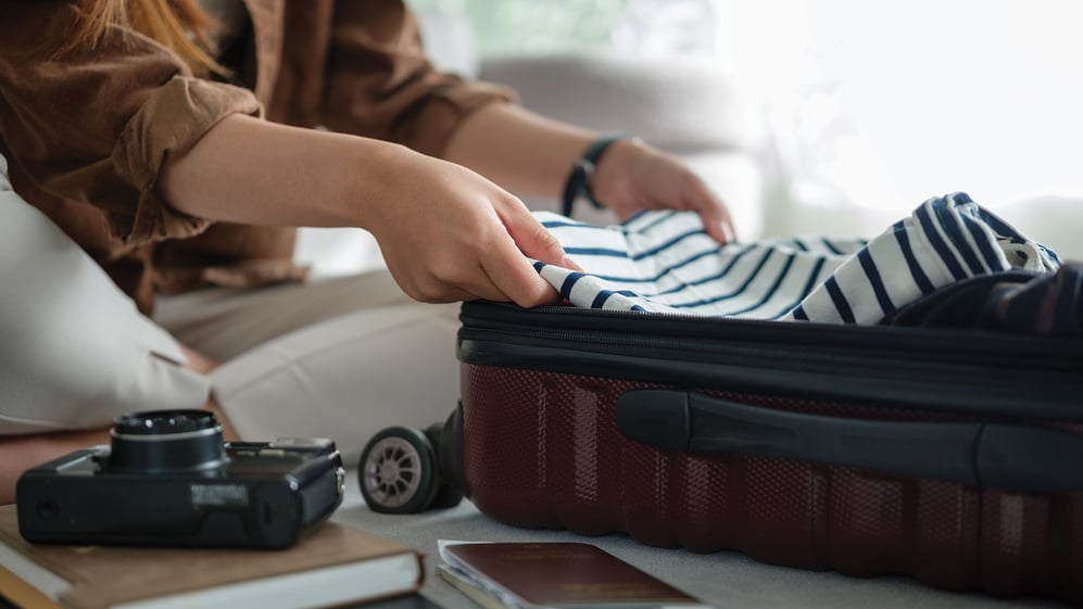 Woman packing up a suitcase