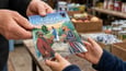 Man handing young child an Arch® Book