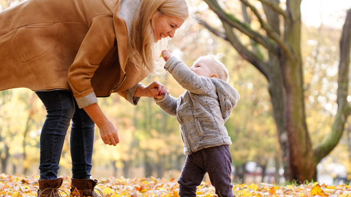 Mother and toddler outside autumn