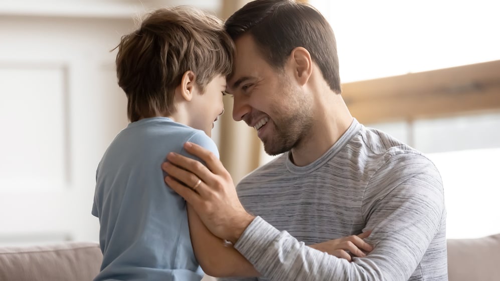 Father embracing young son