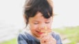 Child embracing a wooden cross