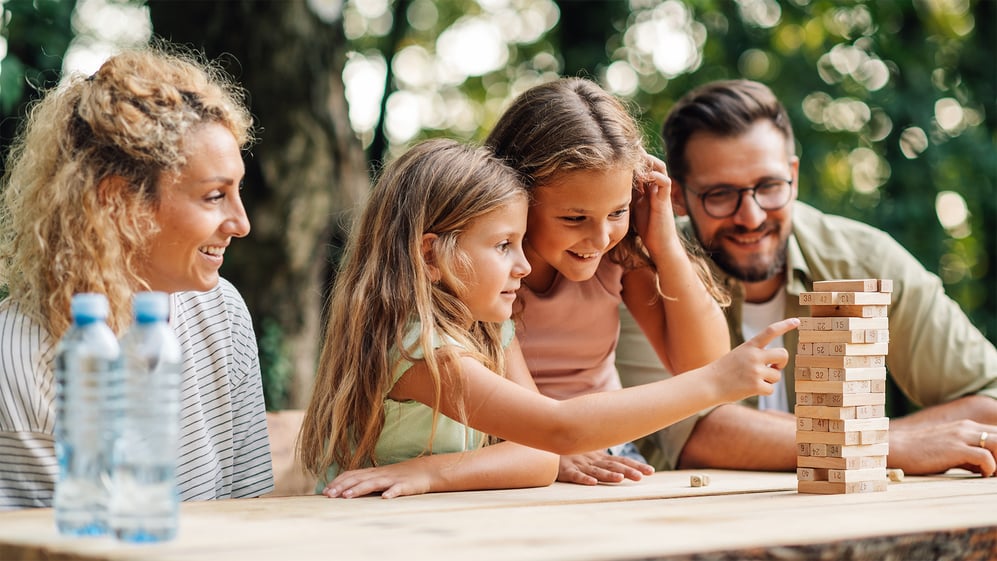 Family plays games at an outdoor church picnic