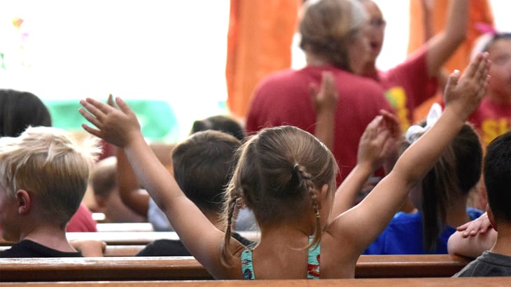 Children engaged in their school chapel service
