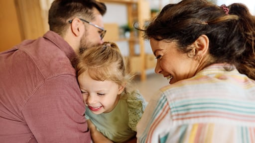 Mother, father, and child embracing