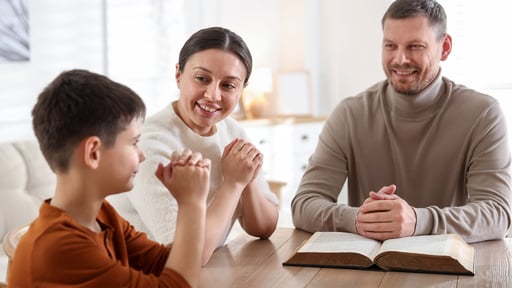 Family reading Scripture and praying together